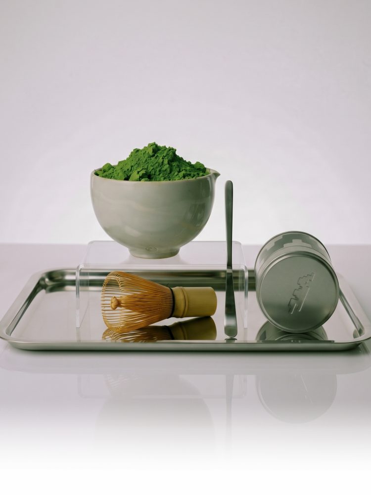 WHISK tin, matcha bowl, whisk, and scoop arranged on a silver tray